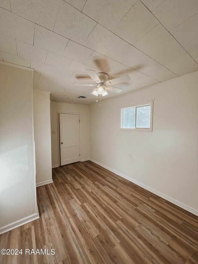 404 W Hickory St, Ville Platte, LA 70586 - unfurnished room with wood finished floors, baseboards, and a ceiling fan