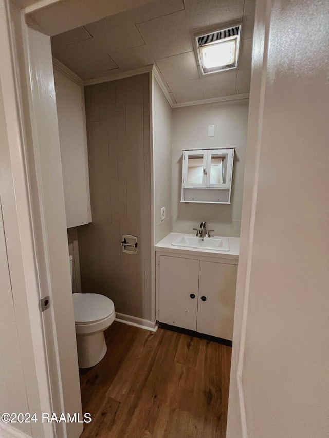 404 W Hickory St, Ville Platte, LA 70586 - bathroom with toilet, wood finished floors, and vanity
