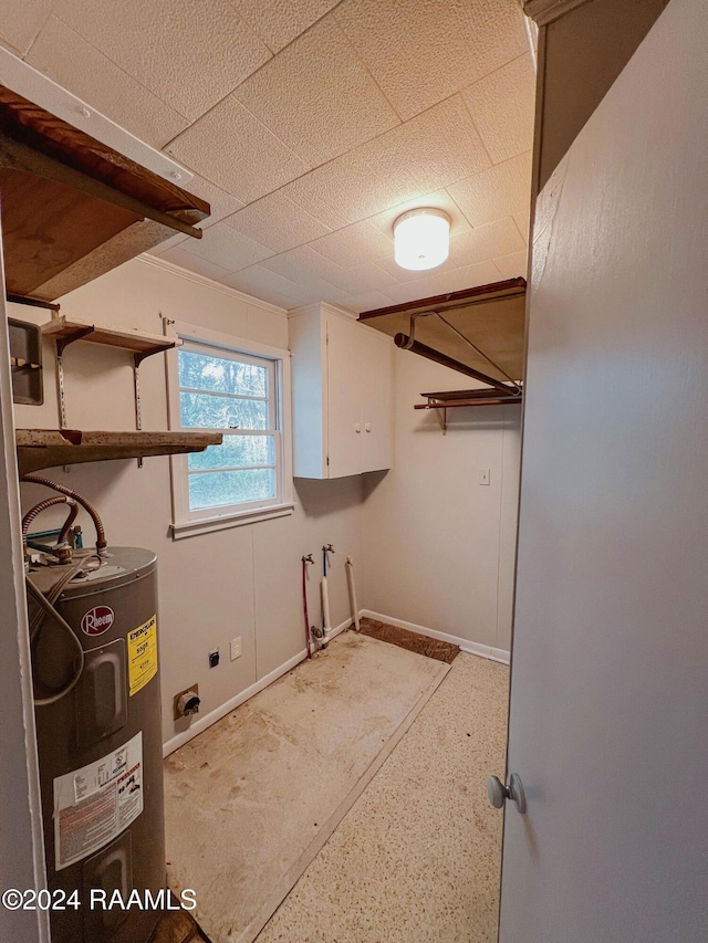 404 W Hickory St, Ville Platte, LA 70586 - laundry room with electric water heater, cabinet space, baseboards, and electric dryer hookup