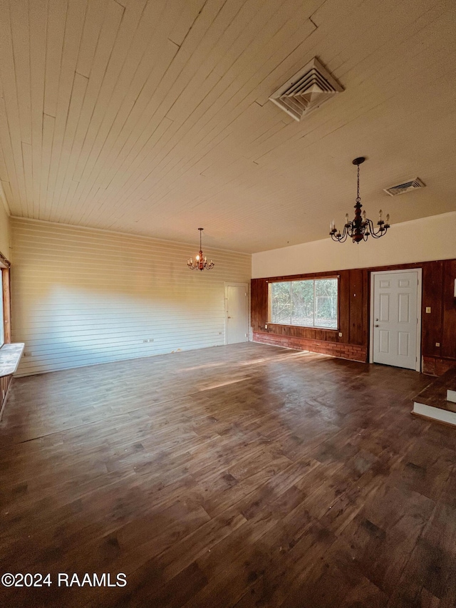 404 W Hickory St, Ville Platte, LA 70586 - unfurnished living room with a chandelier, dark wood finished floors, wooden ceiling, and wooden walls