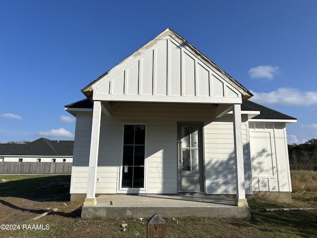 back of property with covered porch