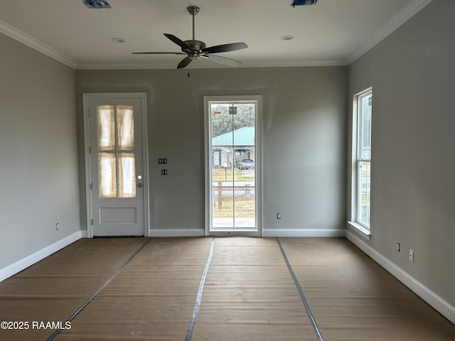 interior space featuring crown molding, a healthy amount of sunlight, and ceiling fan