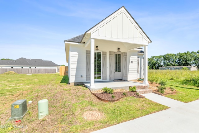 366 W Broussard Rd, Lafayette, LA 70506 - view of front of house with board and batten siding, covered porch, and roof with shingles