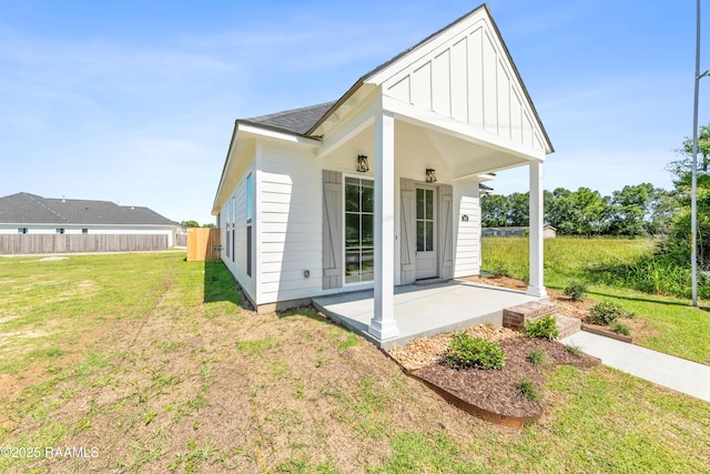 366 W Broussard Rd, Lafayette, LA 70506 - back of property with board and batten siding, covered porch, and a shingled roof
