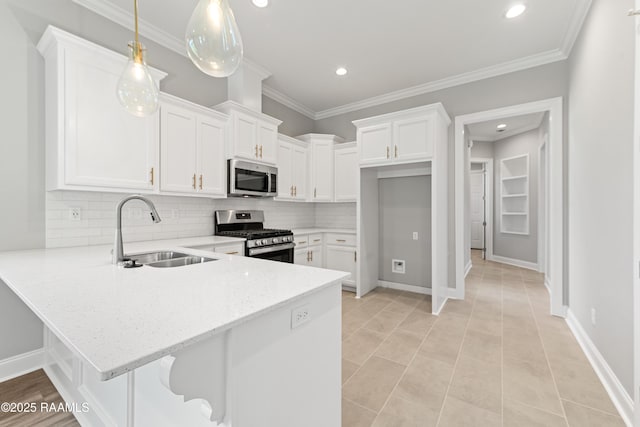 366 W Broussard Rd, Lafayette, LA 70506 - kitchen with stainless steel appliances, a sink, a peninsula, white cabinets, and recessed lighting