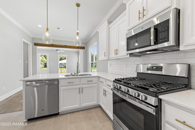 366 W Broussard Rd, Lafayette, LA 70506 - kitchen featuring appliances with stainless steel finishes, a sink, a peninsula, backsplash, and white cabinets