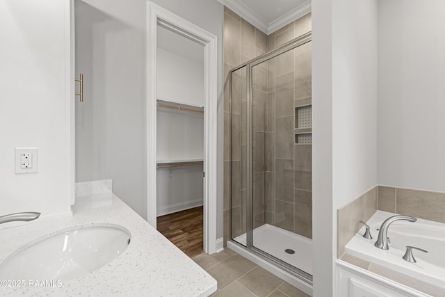 366 W Broussard Rd, Lafayette, LA 70506 - full bathroom with a shower stall, a garden tub, a walk in closet, ornamental molding, and double vanity