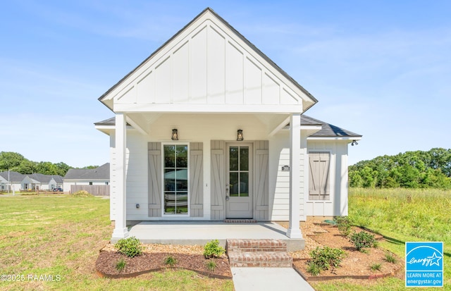 366 W Broussard Rd, Lafayette, LA 70506 - view of front facade with board and batten siding, covered porch, and a front lawn