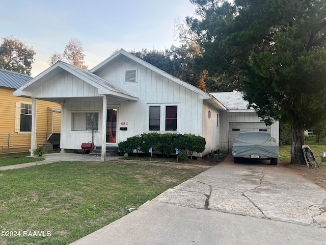 view of front of property with a garage and a front lawn