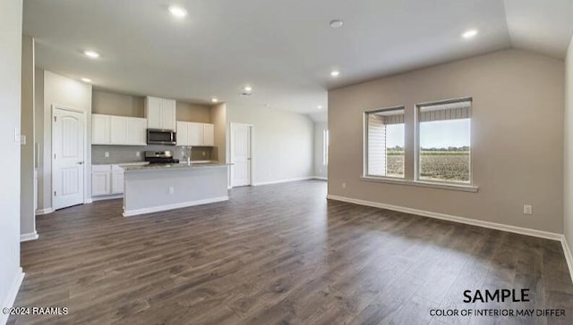 unfurnished living room with lofted ceiling and dark wood-type flooring