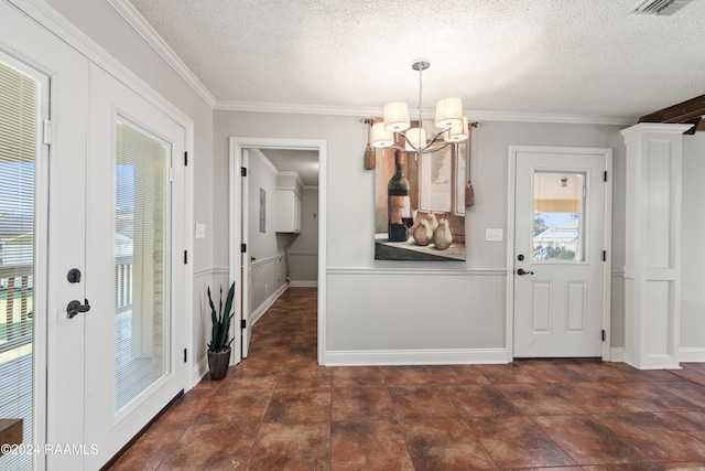 interior space with crown molding, a textured ceiling, a wealth of natural light, and a chandelier