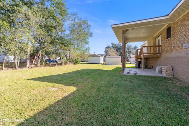 view of yard with a storage unit and a patio