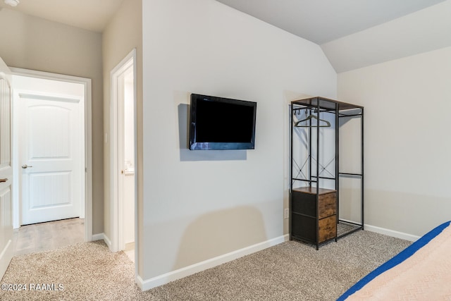 bedroom featuring carpet flooring and lofted ceiling