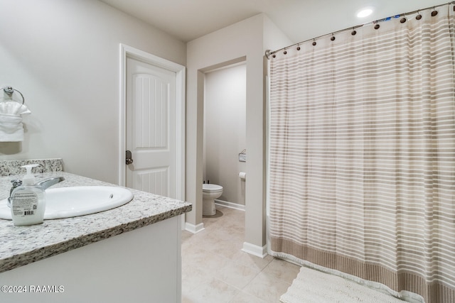 bathroom featuring vanity, toilet, a shower with curtain, and tile patterned flooring