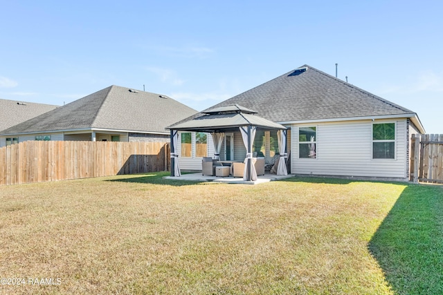 back of property with a gazebo, outdoor lounge area, a patio, and a lawn