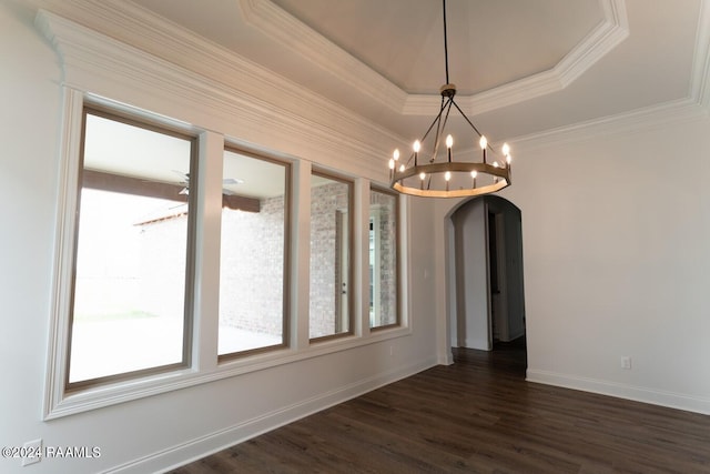 unfurnished dining area with a raised ceiling, dark hardwood / wood-style flooring, and ornamental molding