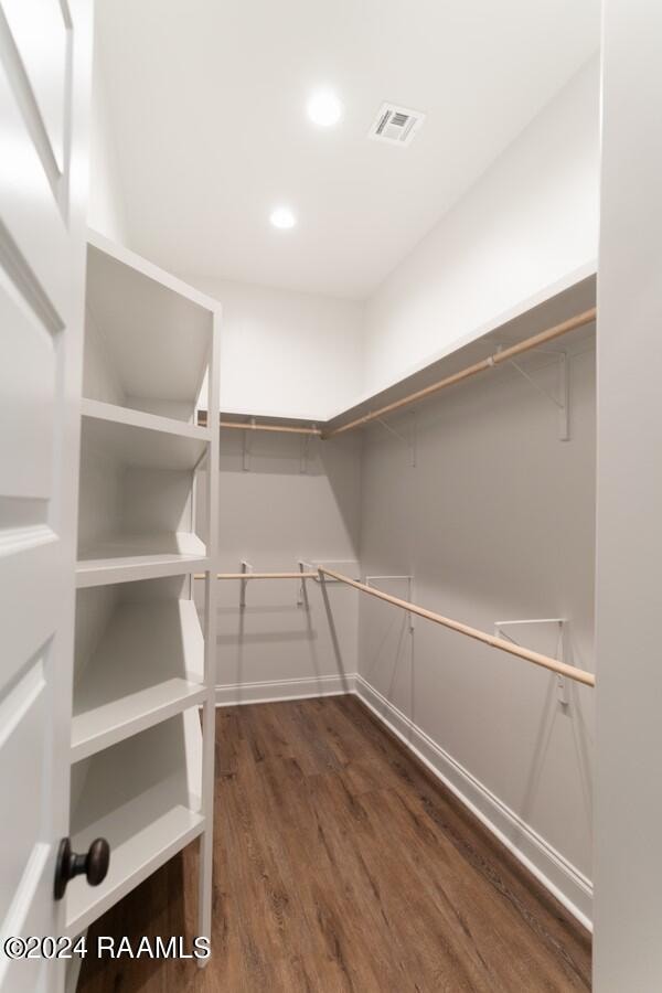 spacious closet with dark hardwood / wood-style floors