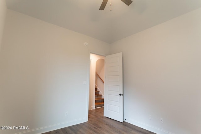 empty room featuring ceiling fan and dark hardwood / wood-style flooring