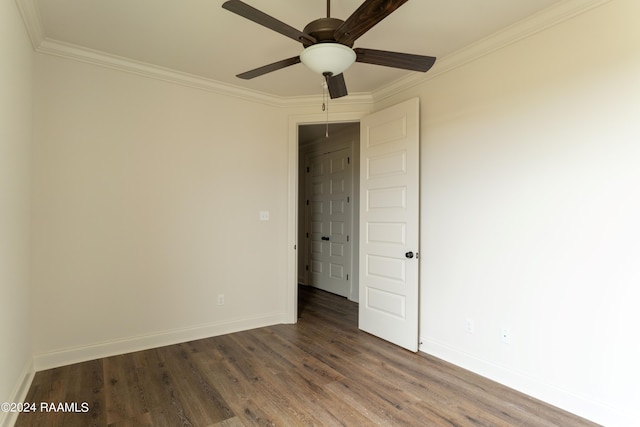 empty room featuring ceiling fan, dark hardwood / wood-style flooring, and ornamental molding