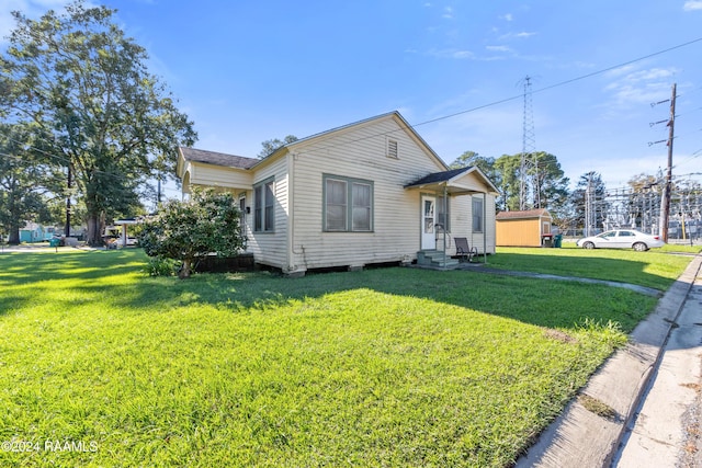 bungalow-style home with a front lawn