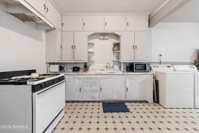 kitchen with white cabinetry, white range with gas stovetop, sink, and washing machine and clothes dryer