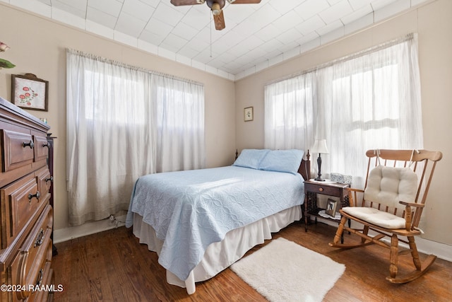 bedroom featuring ceiling fan and dark wood-type flooring