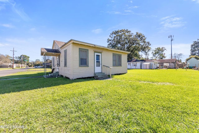 220 Saint Peter St, Lafayette, LA 70506 - rear view of house featuring entry steps and a lawn