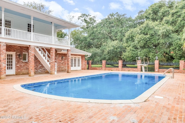 view of pool with a patio and french doors