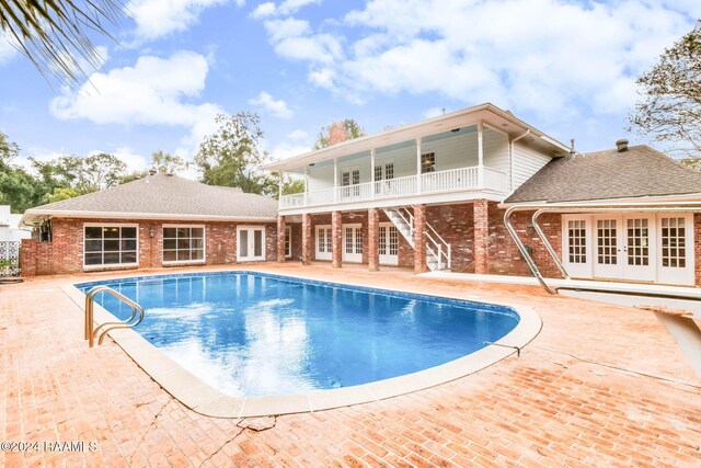 13933 Pumping Plant Rd, Abbeville, LA 70510 - swimming pool featuring french doors, stairway, and a patio area