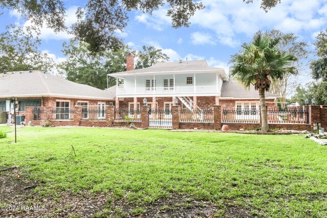 13933 Pumping Plant Rd, Abbeville, LA 70510 - back of property featuring french doors, a chimney, brick siding, and central AC