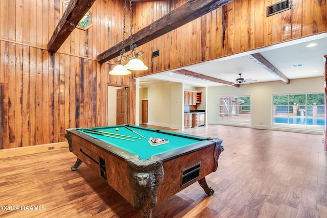 rec room with pool table, wood walls, beamed ceiling, ceiling fan, and light hardwood / wood-style flooring