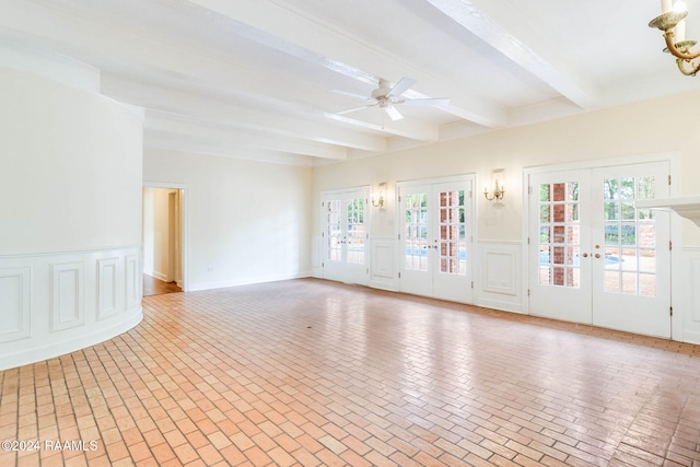 spare room featuring ceiling fan, beamed ceiling, and french doors