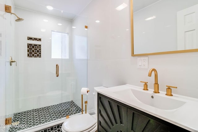 bathroom with walk in shower, vanity, and toilet