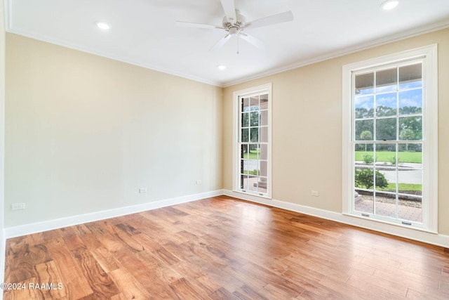 empty room with hardwood / wood-style floors, ceiling fan, and crown molding