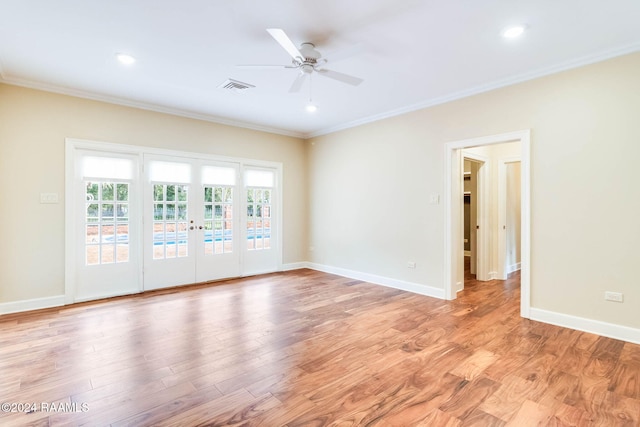 empty room featuring light hardwood / wood-style floors, ceiling fan, crown molding, and french doors