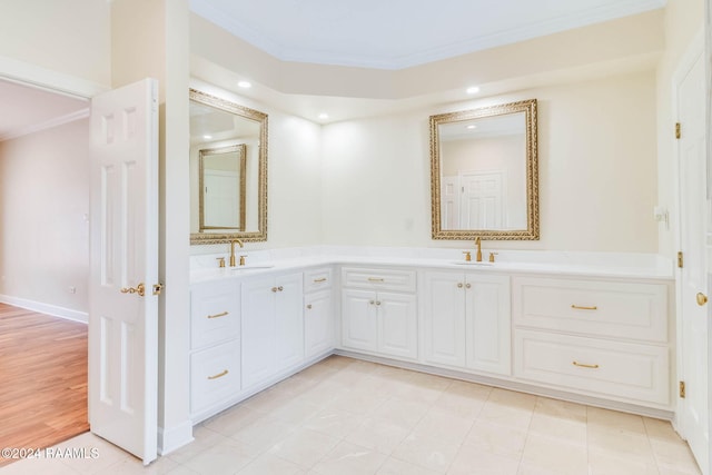 bathroom featuring vanity, hardwood / wood-style flooring, and crown molding