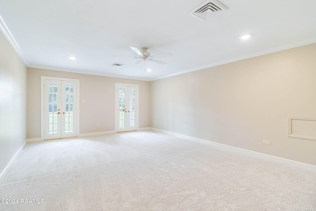 spare room featuring ceiling fan, french doors, light carpet, and ornamental molding