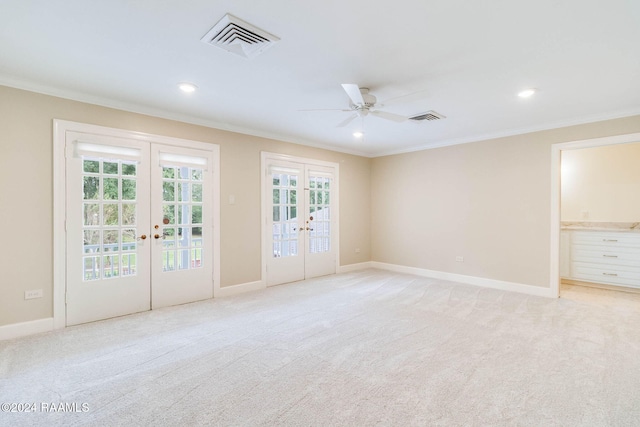 unfurnished room with french doors, light carpet, crown molding, and ceiling fan