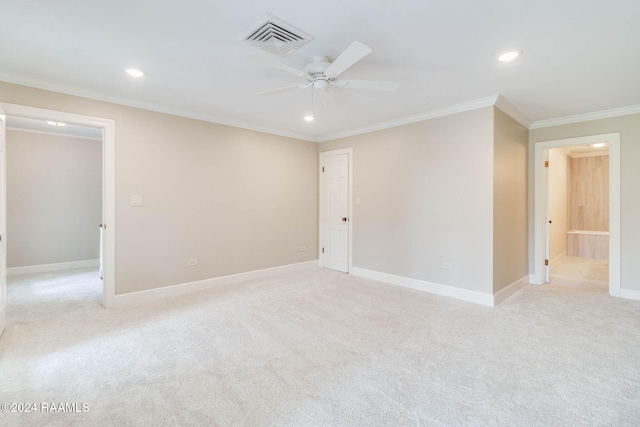 unfurnished room featuring ceiling fan, light colored carpet, and ornamental molding