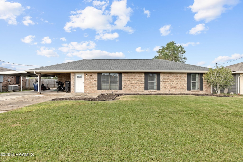 ranch-style home featuring a front yard and a carport