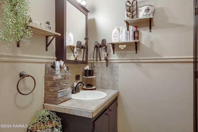 bathroom with tasteful backsplash and vanity