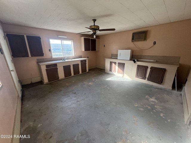 kitchen featuring an AC wall unit, concrete flooring, and ceiling fan