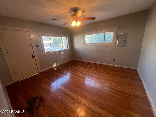 unfurnished room with electric panel, wood-type flooring, and ceiling fan