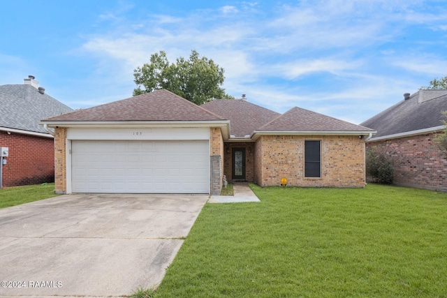 single story home featuring a front lawn and a garage