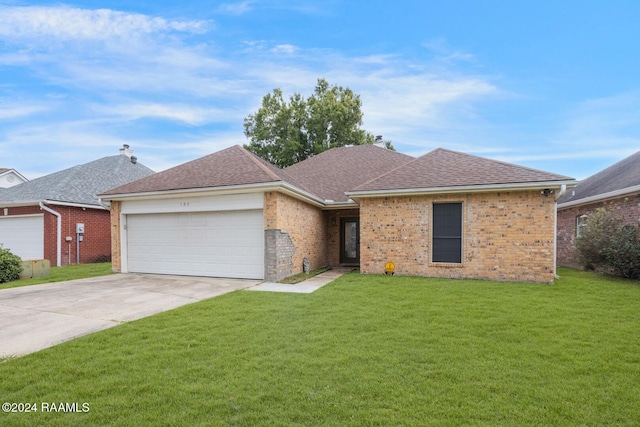 ranch-style home featuring a garage and a front lawn