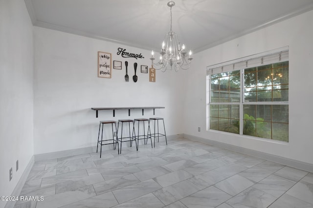 unfurnished dining area featuring a chandelier and ornamental molding