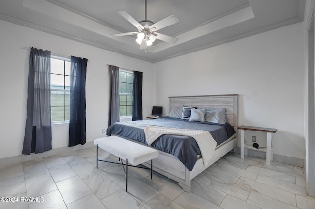 bedroom featuring ornamental molding, ceiling fan, and a raised ceiling