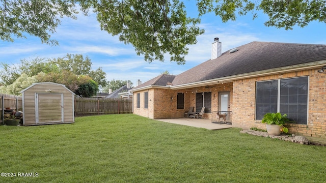 back of property with a storage shed, a yard, and a patio area