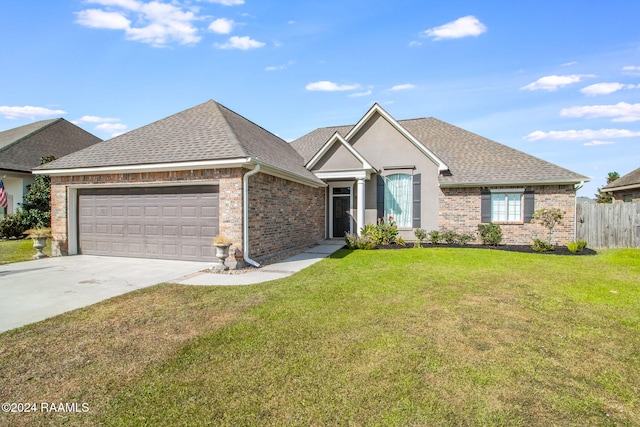 view of front of property featuring a front yard and a garage