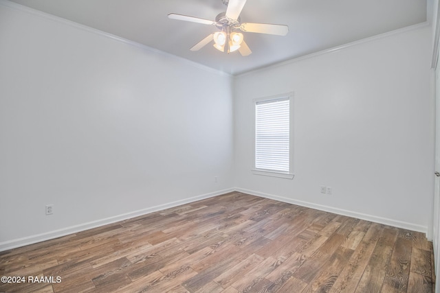 empty room with ceiling fan, hardwood / wood-style flooring, and ornamental molding